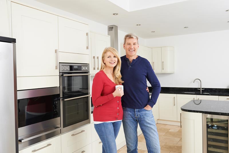 Couple standing together in the kitchen of their home